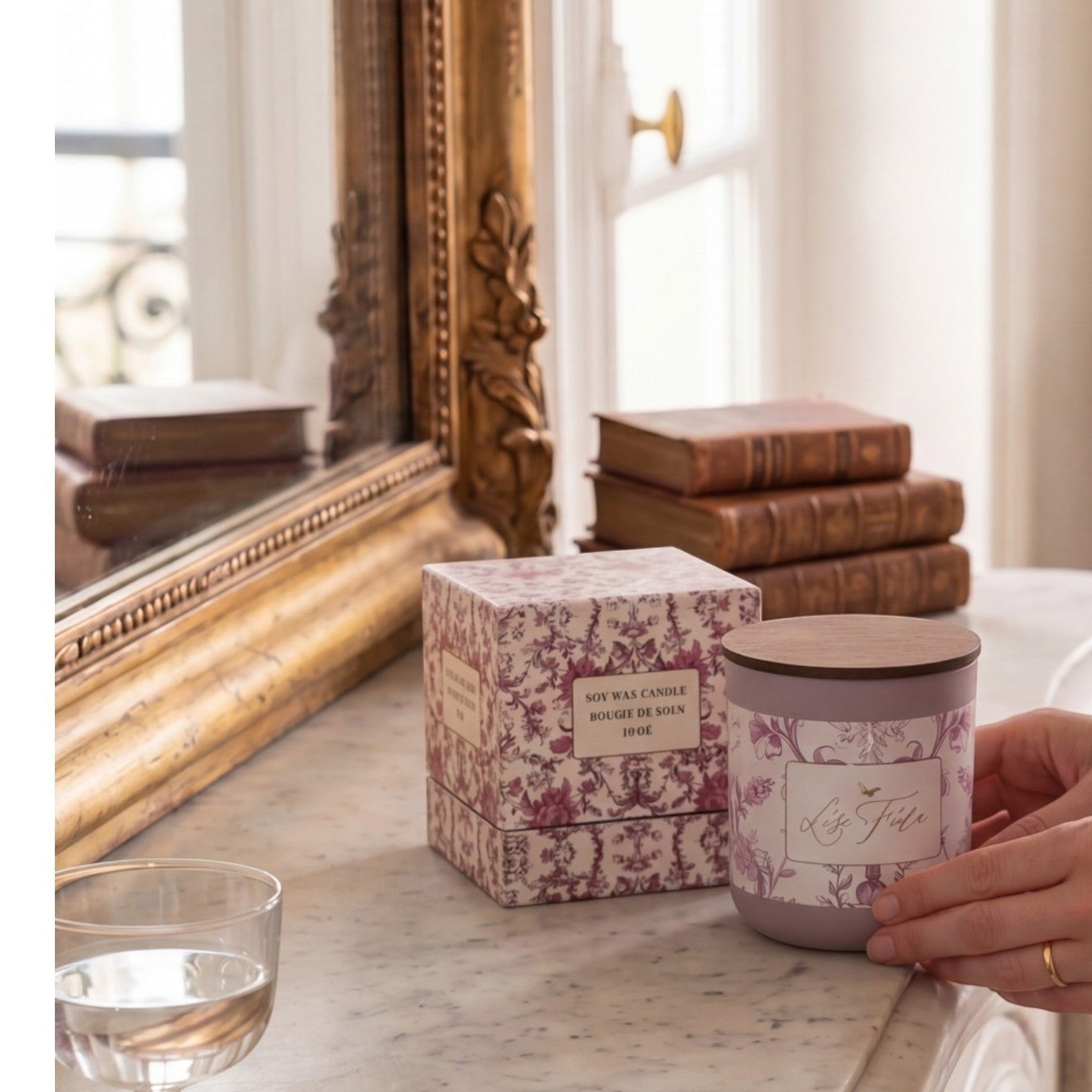 Lise Fiola Creations red berry citrus soy wax candle in a floral patterned jar with a wooden lid and keepsake box.