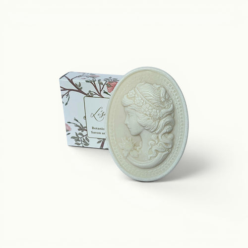 Lise Fiola Creations artisanal cameo soap bar with detailed floral relief design and matching botanical gift box.