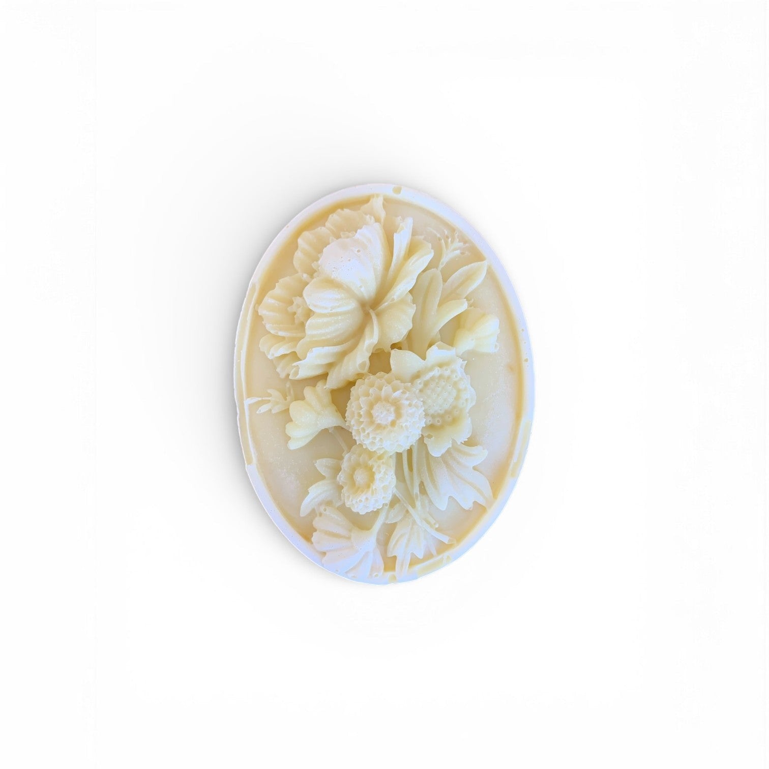 Lise Fiola Creations artisanal oval soap bar featuring an intricate embossed floral bouquet design in cream white.
