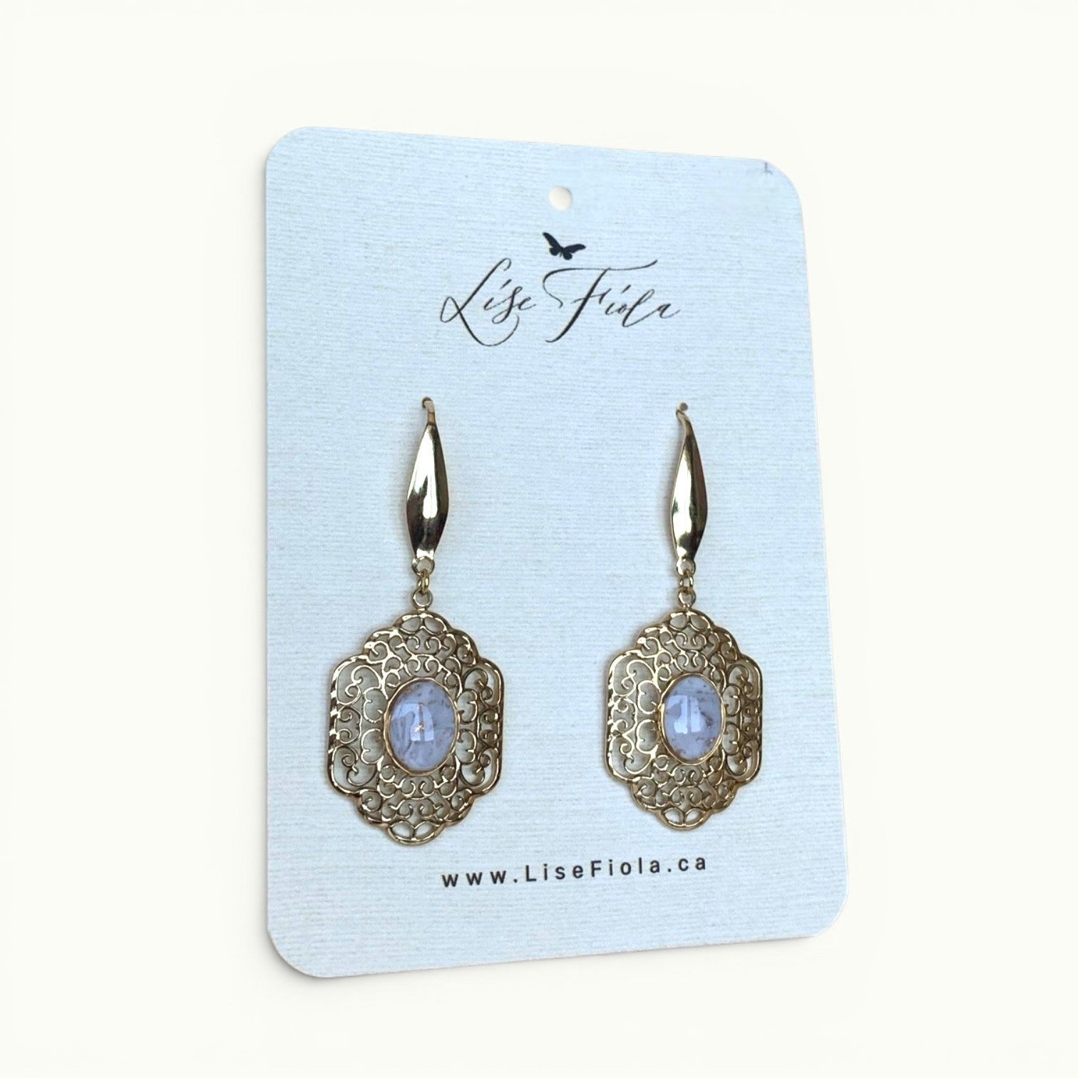 Lise Fiola Creations gold-tone filigree earrings with marbled cabochons on a branded display card.