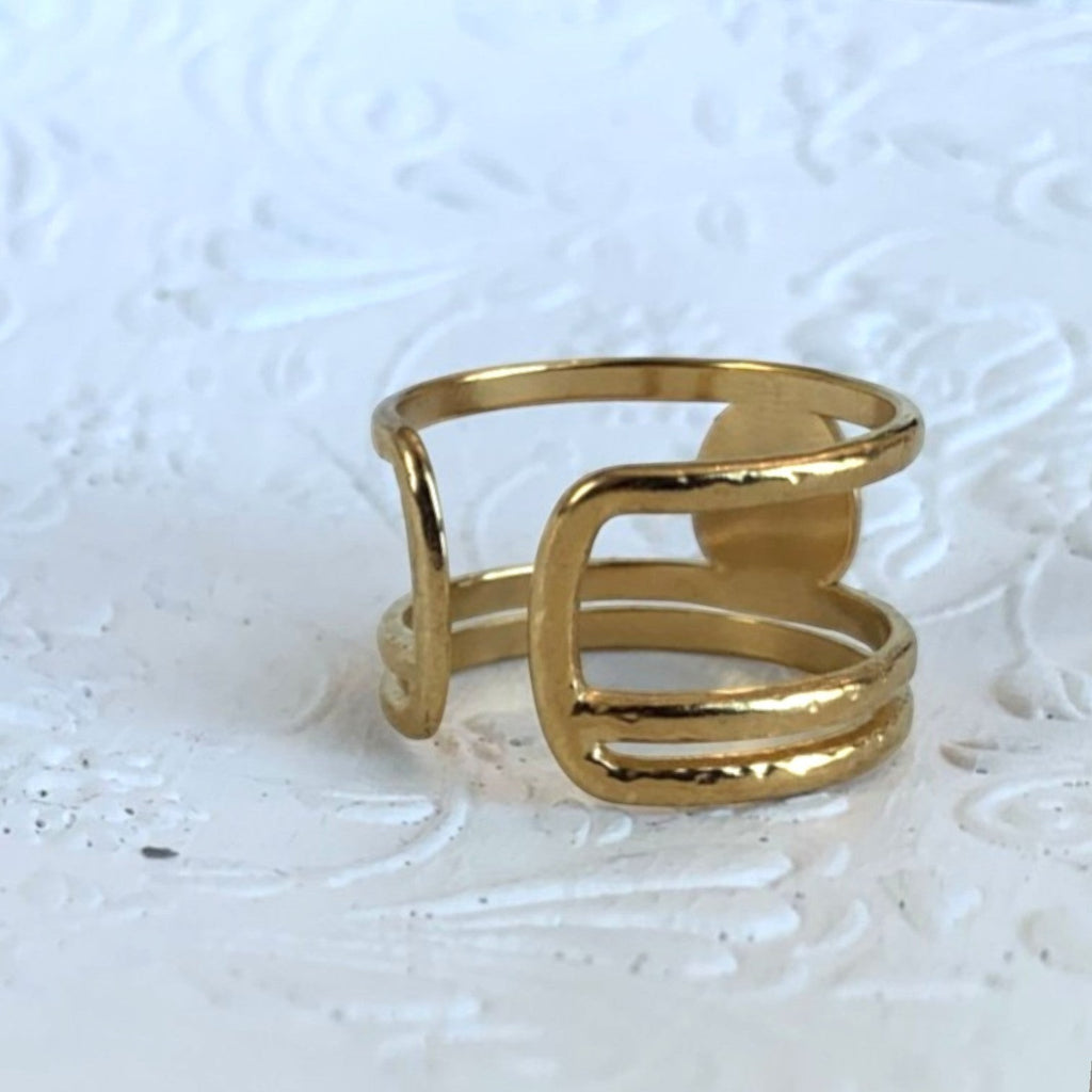 Lise Fiola Creations triple band adjustable ring in 18k gold plated stainless steel on a white textured surface
