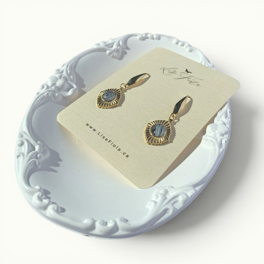 Lise Fiola Creations Golden Eye earrings featuring marbled grey polymer clay set in 18k gold-plated brass frames.