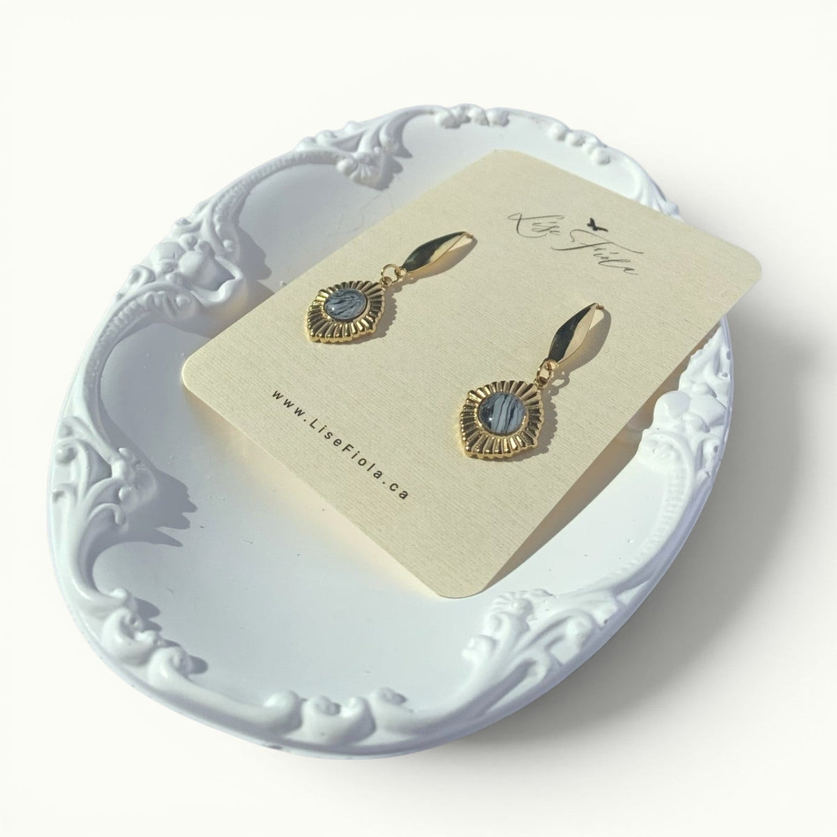 Lise Fiola Creations Golden Eye earrings featuring marbled grey polymer clay set in 18k gold-plated brass frames.