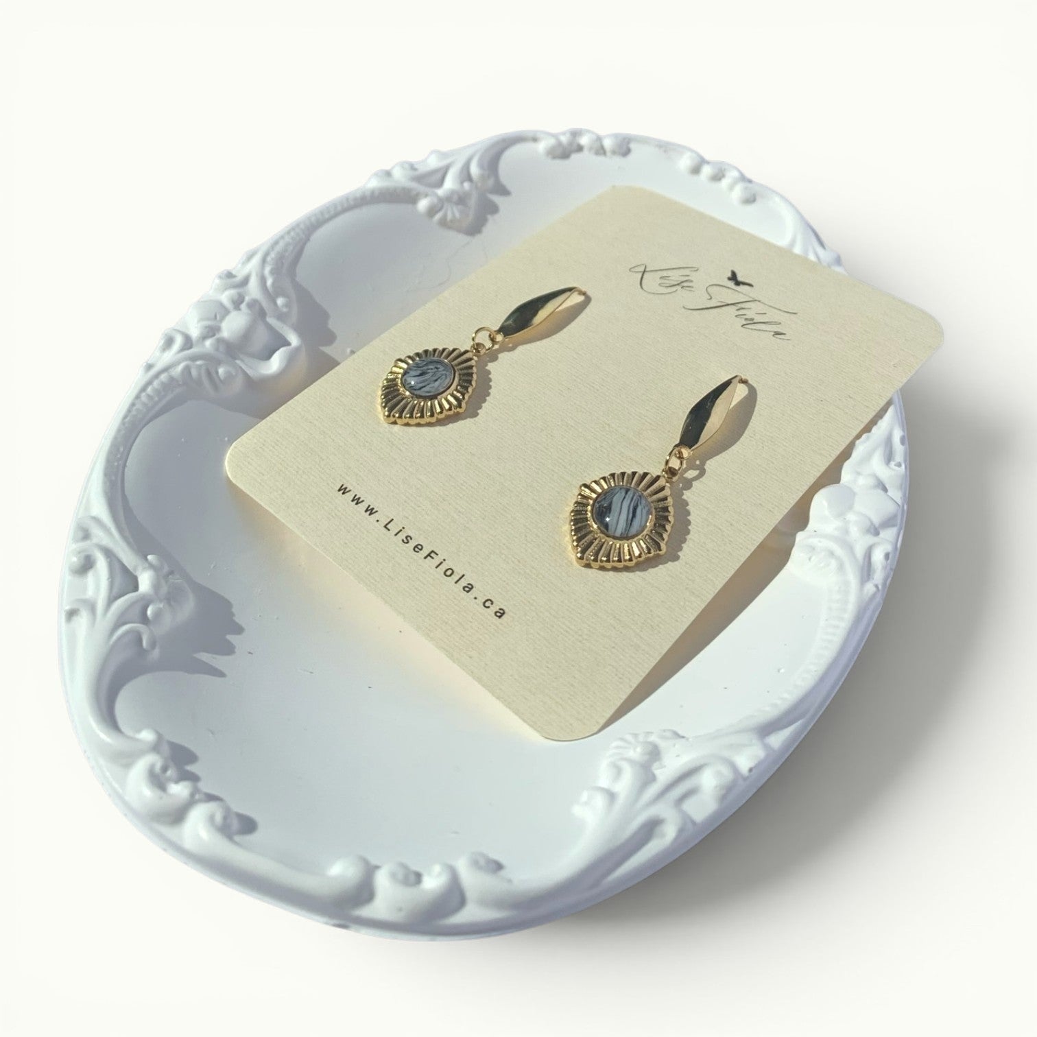 Lise Fiola Creations Golden Eye earrings featuring marbled grey polymer clay set in 18k gold-plated brass frames.