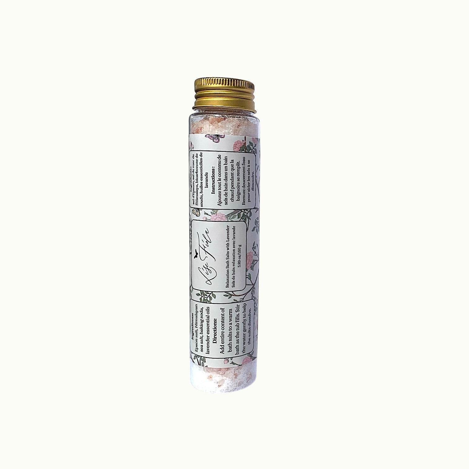 Lise Fiola Creations relaxation bath salts in a clear glass tube with a gold lid and floral label.
