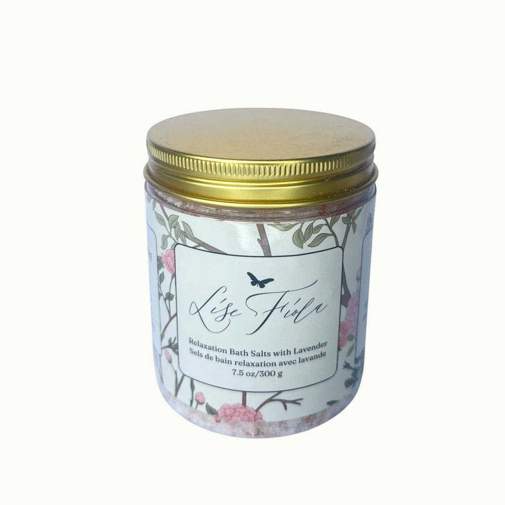 Lise Fiola Creations relaxation bath salts in a clear jar with a gold lid and floral botanical label