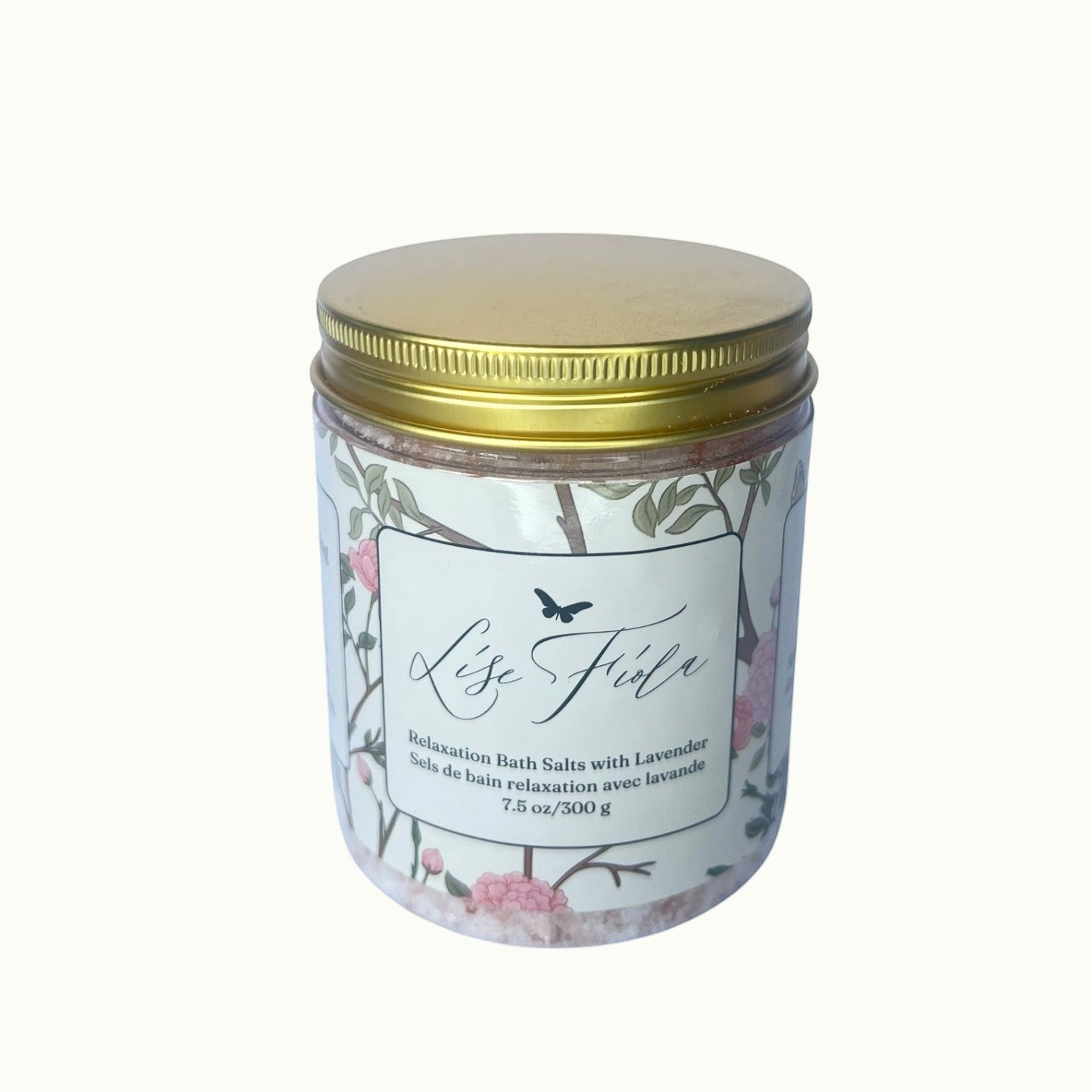 Lise Fiola Creations relaxation bath salts in a clear jar with a gold lid and floral botanical label