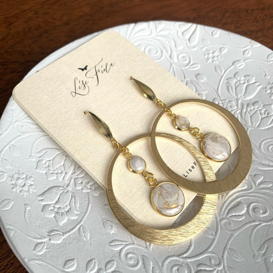 Lise Fiola Creations Luna earrings featuring gold-plated brass hoops and marbled polymer clay in neutral tones.