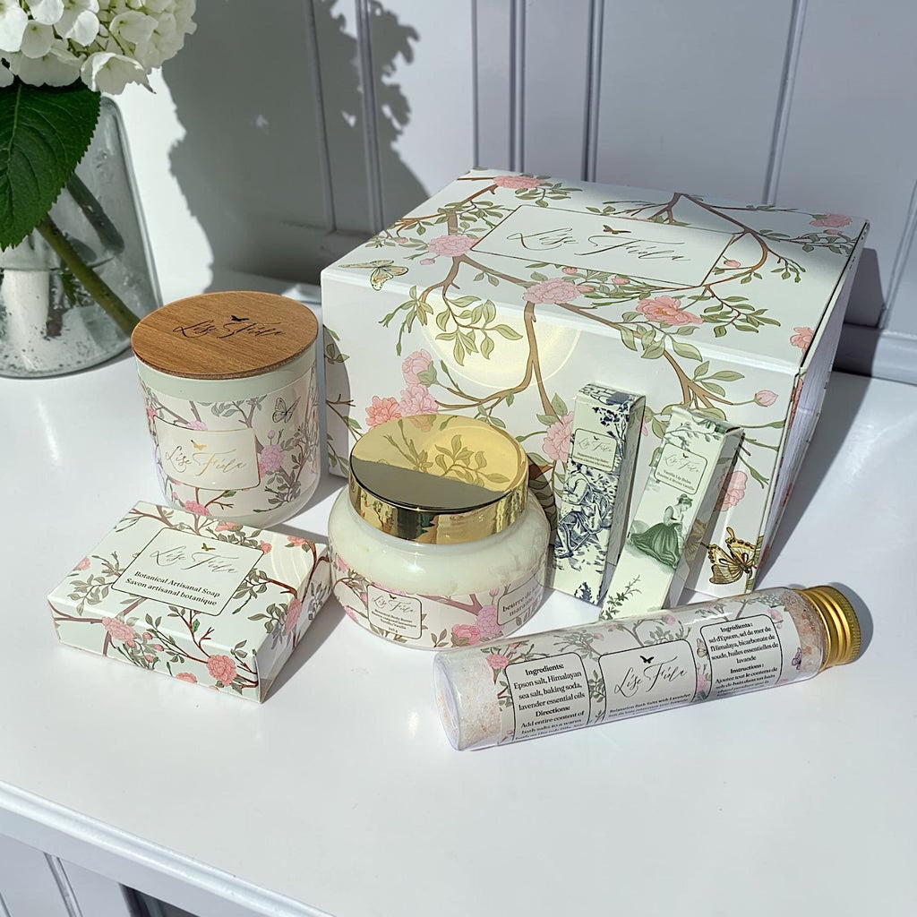 Lise Fiola Creations luxurious self-care gift set in a floral magnetic box with body butter, soap, candle, and salts.