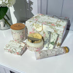 Lise Fiola Creations luxurious self-care gift set in a floral magnetic box with body butter, soap, candle, and salts.