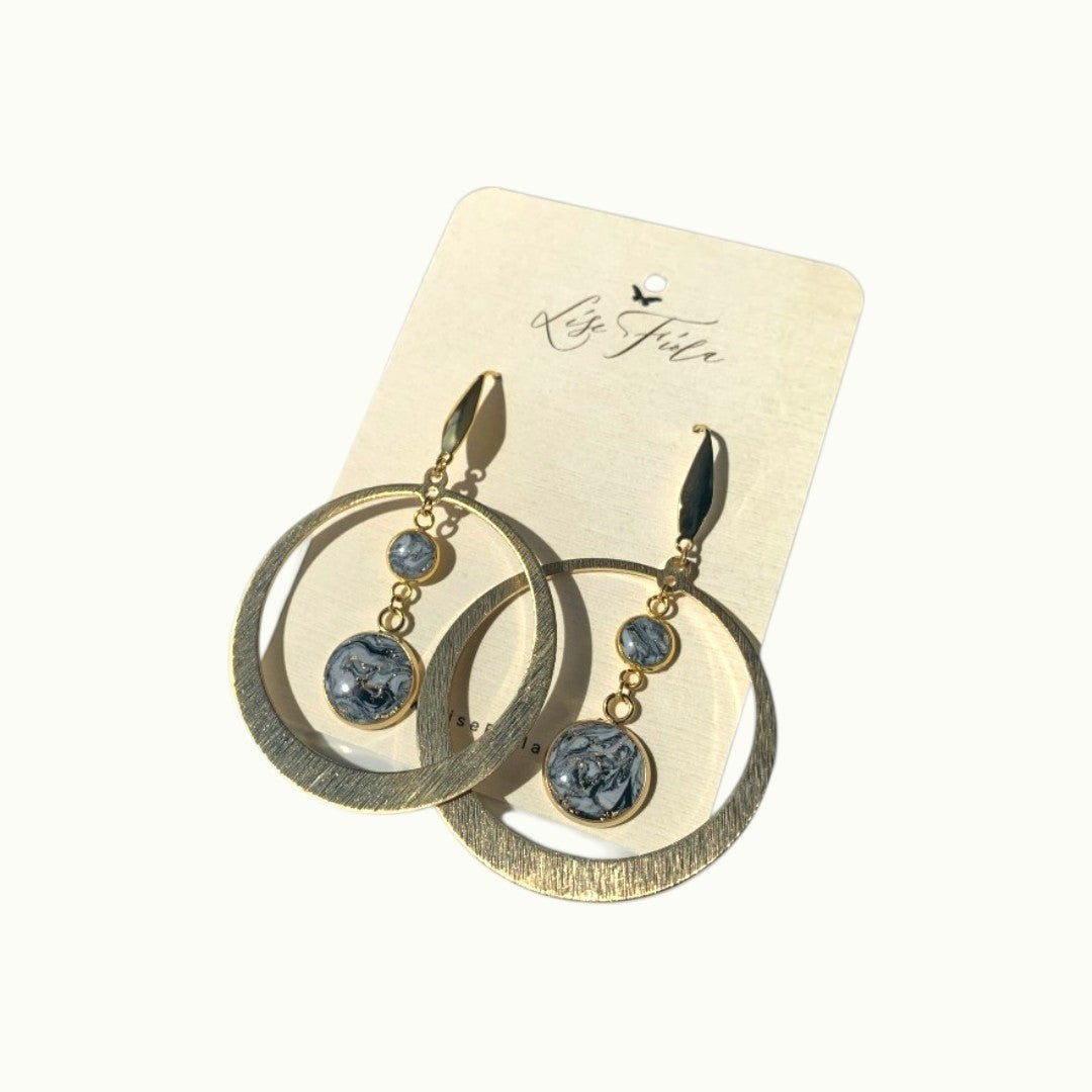 Lise Fiola Creations Marble Luna earrings featuring gold-plated brass hoops and black, grey, and white marbled clay.
