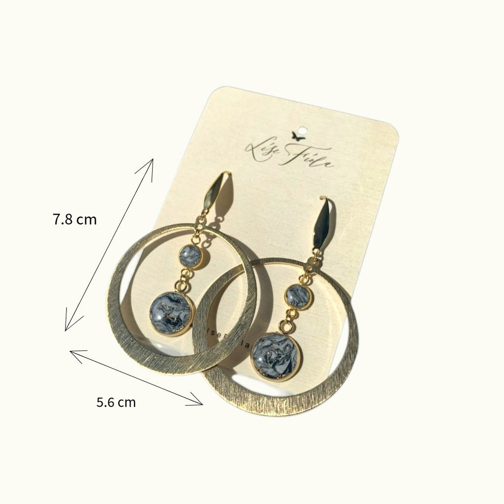 Lise Fiola Creations Marble Luna earrings featuring gold-plated brass hoops and black, grey, and white marbled clay charms.