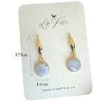 Lise Fiola Creations handmade polymer clay earrings featuring marbled grey and white discs with 18k gold-plated accents.