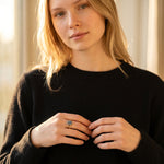 Lise Fiola Creations handmade marbled polymer clay ring with gold plated band worn by a woman in a black sweater