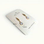 Lise Fiola Creations Dot Drop earrings featuring marbled polymer clay in beige and white with 14k gold-plated accents.