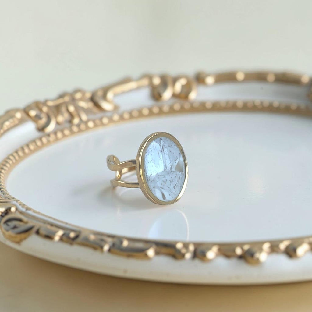 Lise Fiola Creations oval ring with light marble polymer clay and 18k gold plated adjustable stainless steel band.