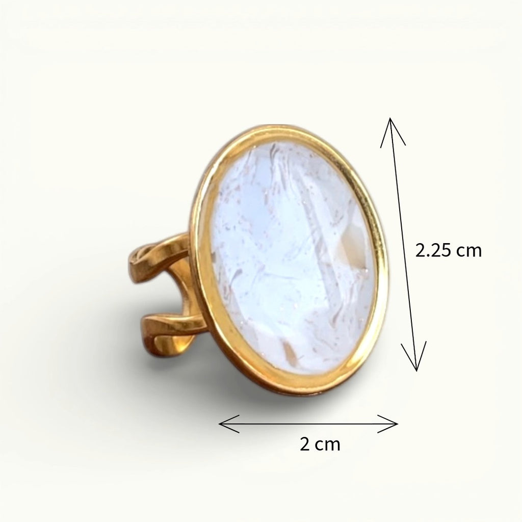 Lise Fiola Creations oval ring with light beige and gold marbled polymer clay on an adjustable gold plated band.