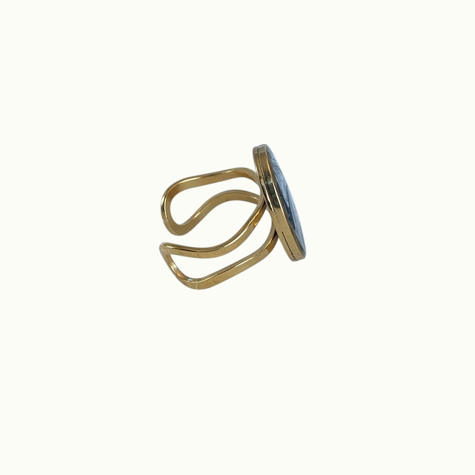 Lise Fiola Creations adjustable oval ring with a black, grey, and gold marbled polymer clay inlay on a gold band.