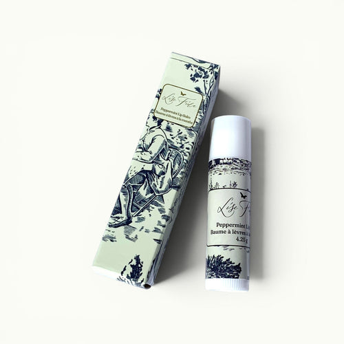 Lise Fiola Creations peppermint beeswax lip balm in elegant toile de Jouy packaging with a matching tube.
