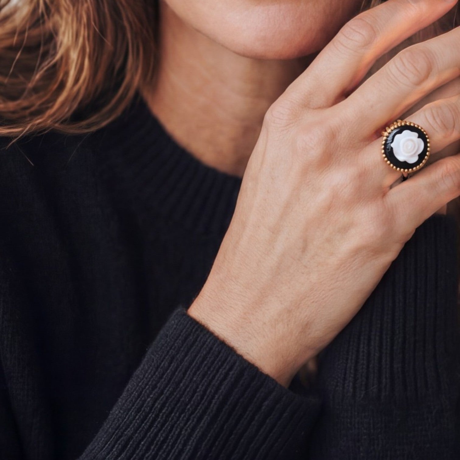 Lise Fiola Creations handcrafted adjustable gold ring with a white polymer clay rose on a black background