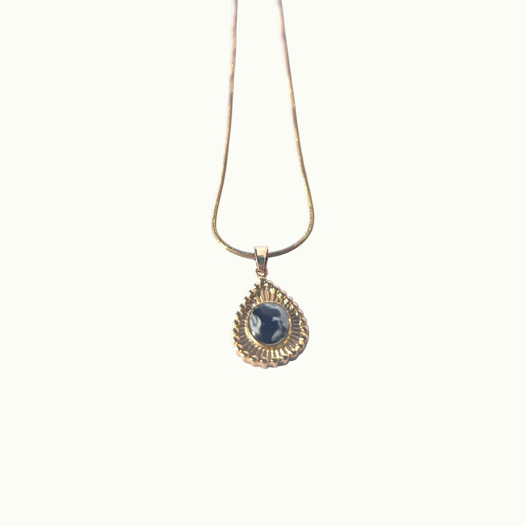 Lise Fiola Creations Sun Ray Drop necklace with a dark marbled polymer clay pendant in a 14K gold-plated bezel.