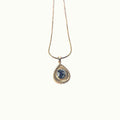 Lise Fiola Creations Sun Ray Drop necklace with a dark marbled polymer clay pendant in a 14K gold-plated bezel.