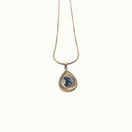 Lise Fiola Creations Sun Ray Drop necklace with a dark marbled polymer clay pendant in a 14K gold-plated bezel.