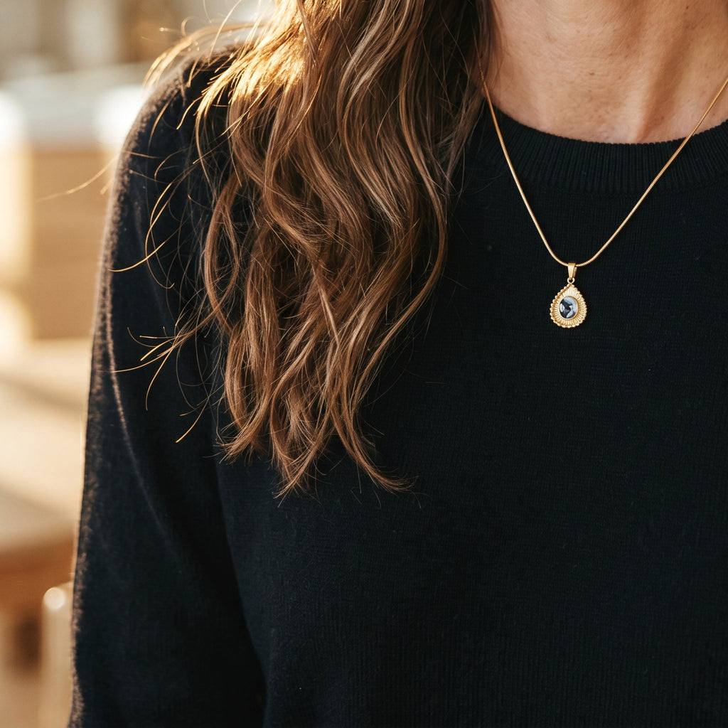 Lise Fiola Creations Sun Ray Drop necklace with dark marbled polymer clay in a 14K gold-plated bezel on a snake chain