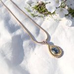 Lise Fiola Creations Sun Ray Drop necklace with dark marbled polymer clay in a 14K gold-plated bezel on a snake chain.