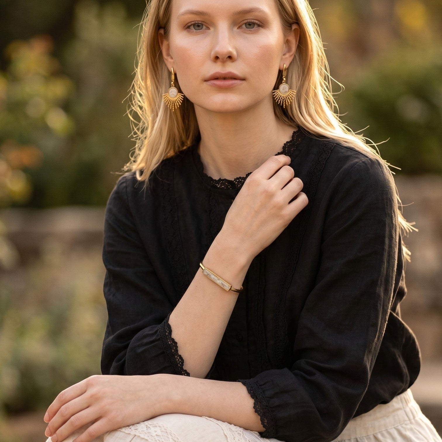Lise Fiola Creations Sun Ray earrings featuring marbled polymer clay and 14k gold-plated accents worn by a model.