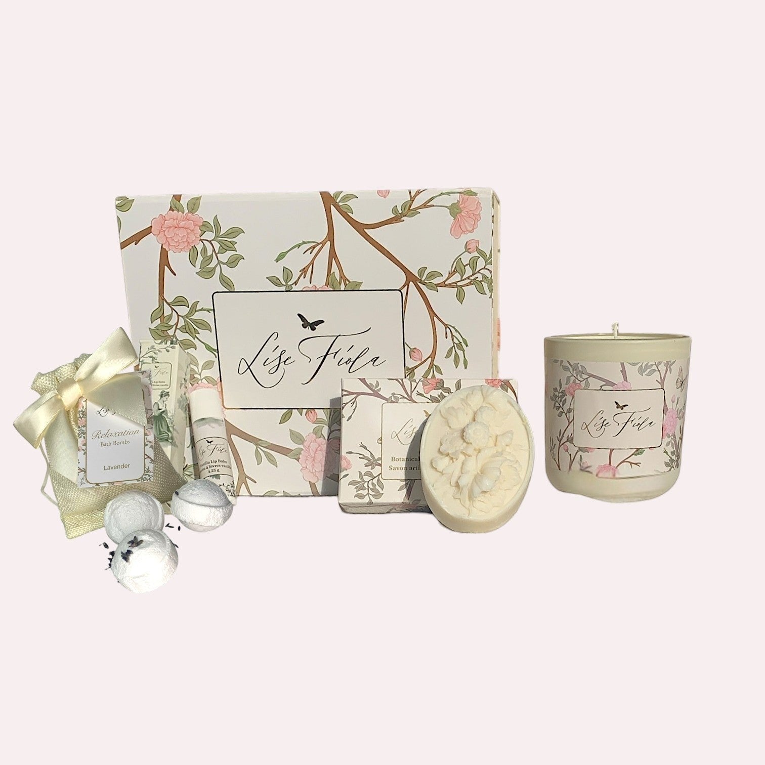 Lise Fiola Creations Tranquil Retreat gift set featuring a floral keepsake box, bath bomb, botanical soap, and candle.