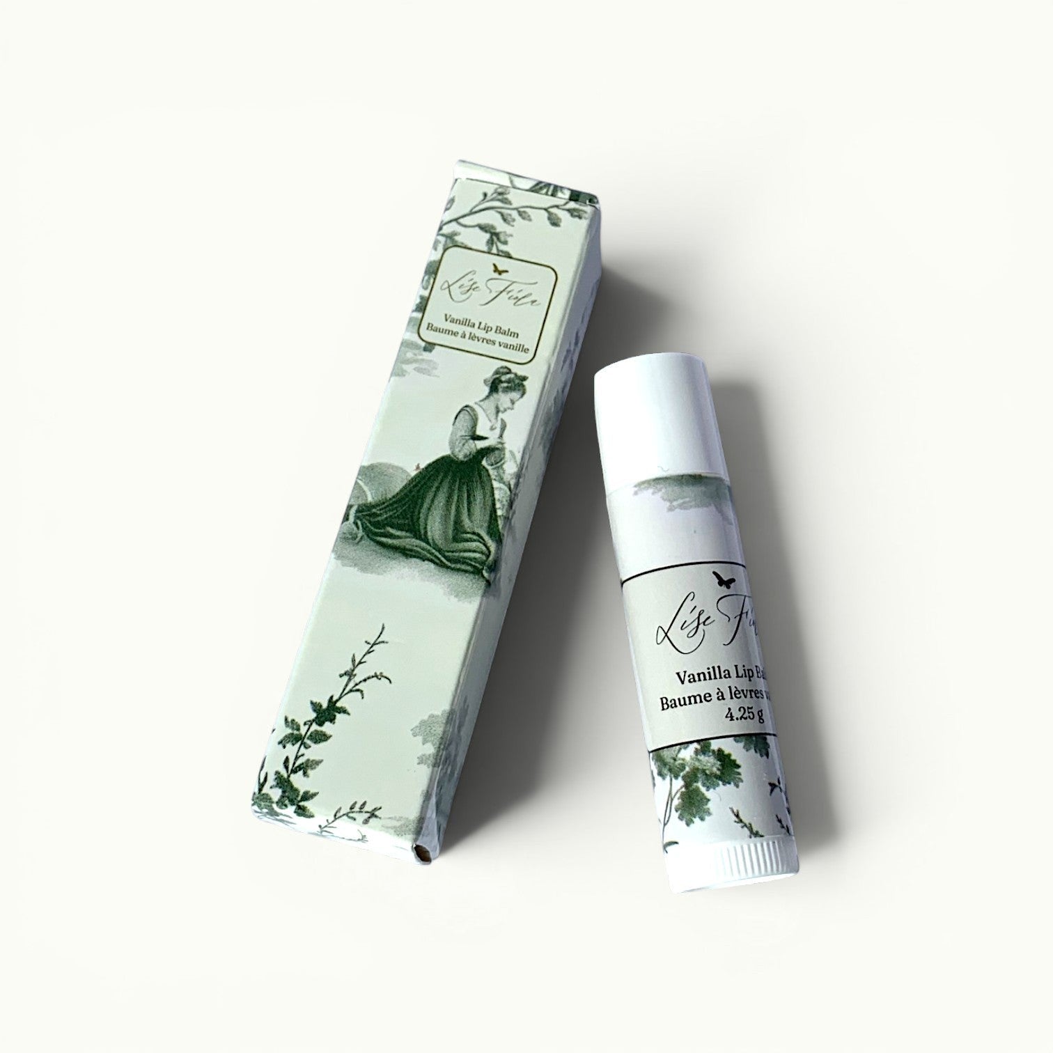 Lise Fiola Creations vanilla beeswax lip balm with elegant green Toile de Jouy packaging and matching tube.