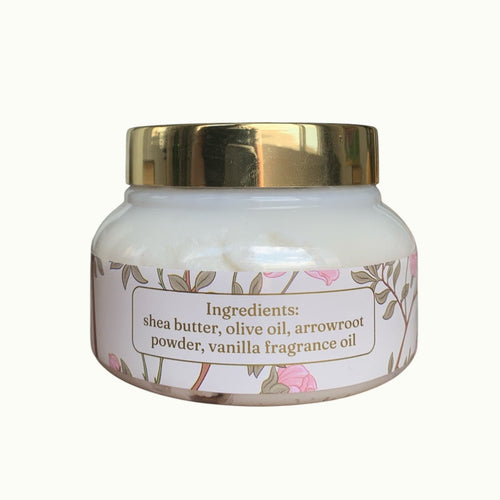 Lise Fiola Creations vanilla body butter in a glass jar with a gold lid and floral label featuring ingredients list.