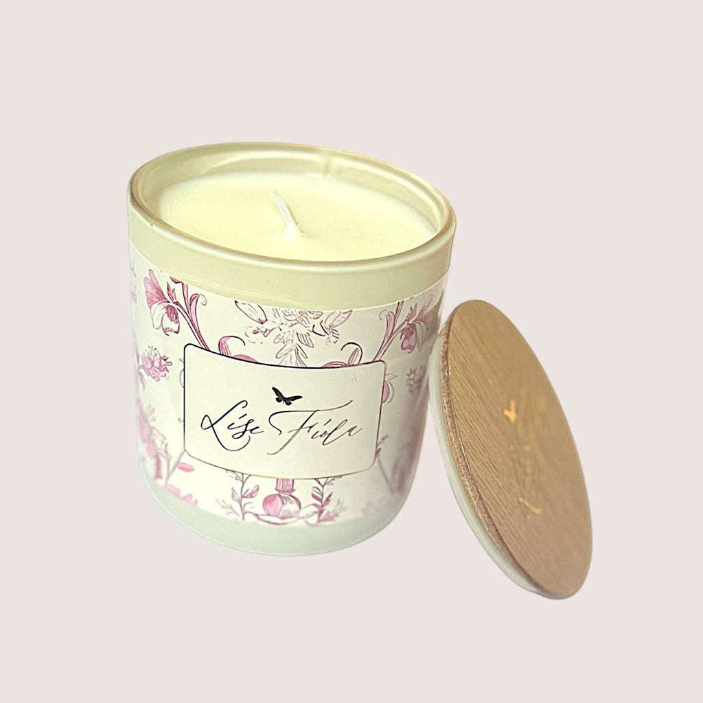 Lise Fiola Creations 10 oz vanilla coconut soy wax candle in a floral patterned glass jar with a wooden lid.