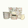 Lise Fiola Creations Warm Embrace gift set with vanilla body butter, botanical soap, and candle in a floral box.