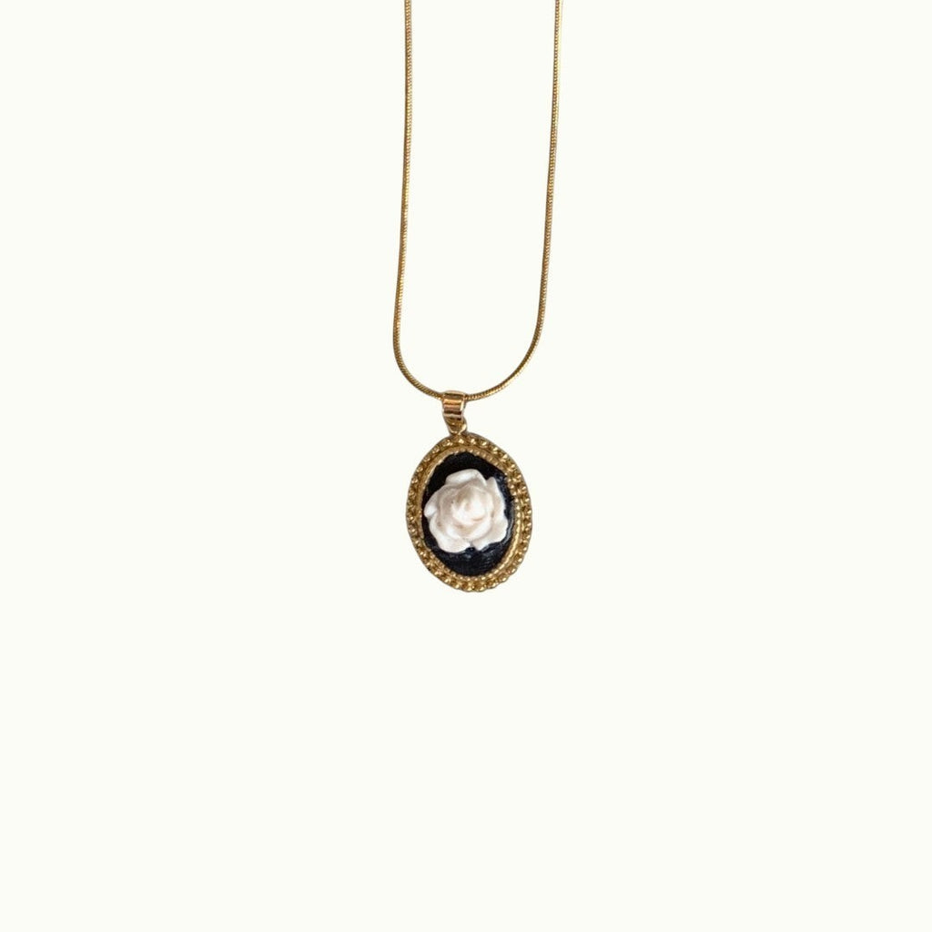 Lise Fiola Creations necklace featuring a handcrafted white polymer clay rose on black in an 18k gold-plated bezel.