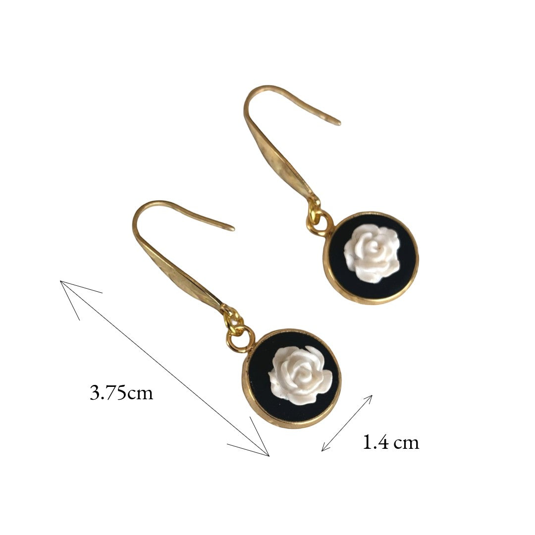 Lise Fiola Creations handmade drop earrings featuring white polymer clay roses on black discs with 18k gold-plated hooks.