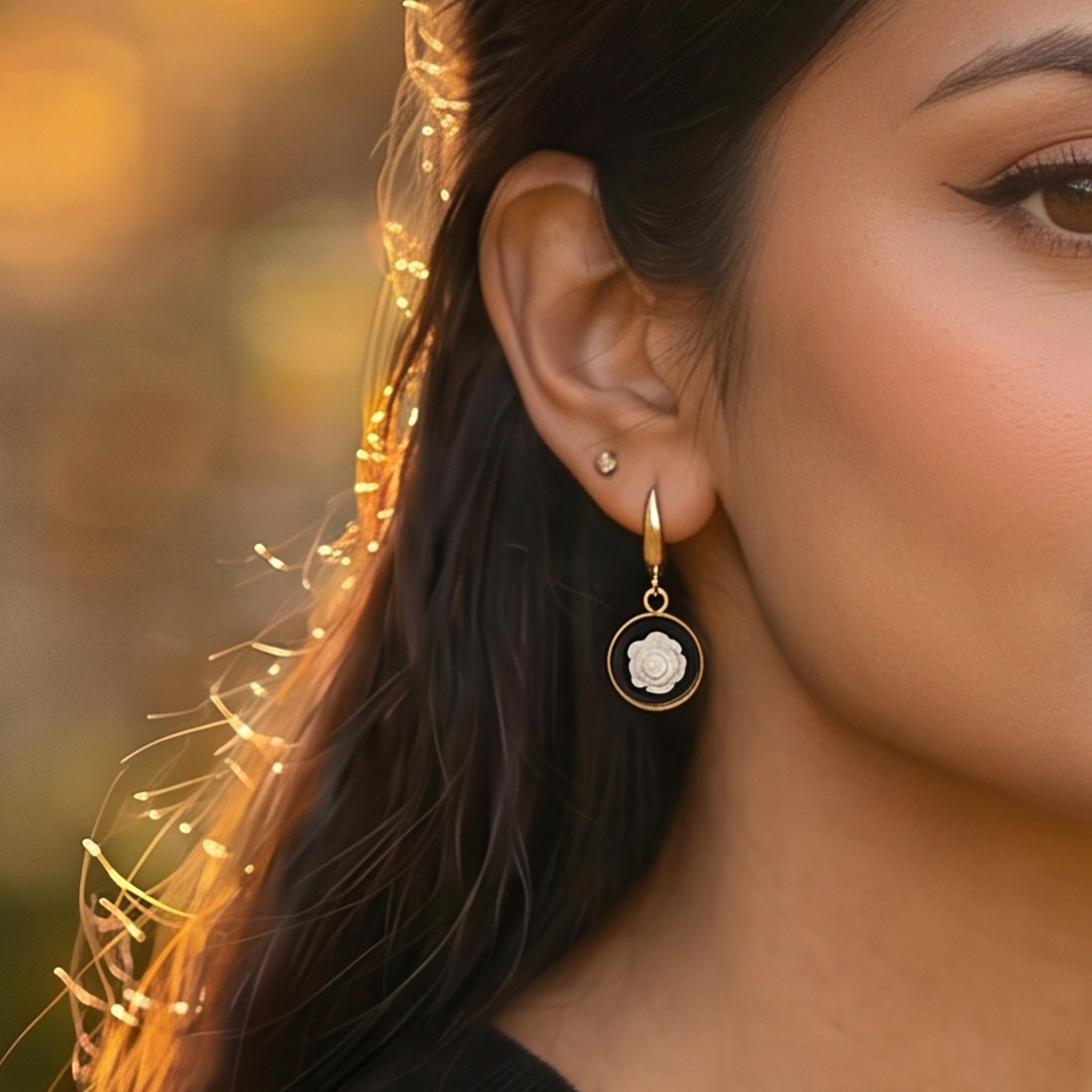 Lise Fiola Creations white rose drop earrings featuring polymer clay flowers in gold-plated brass on a model