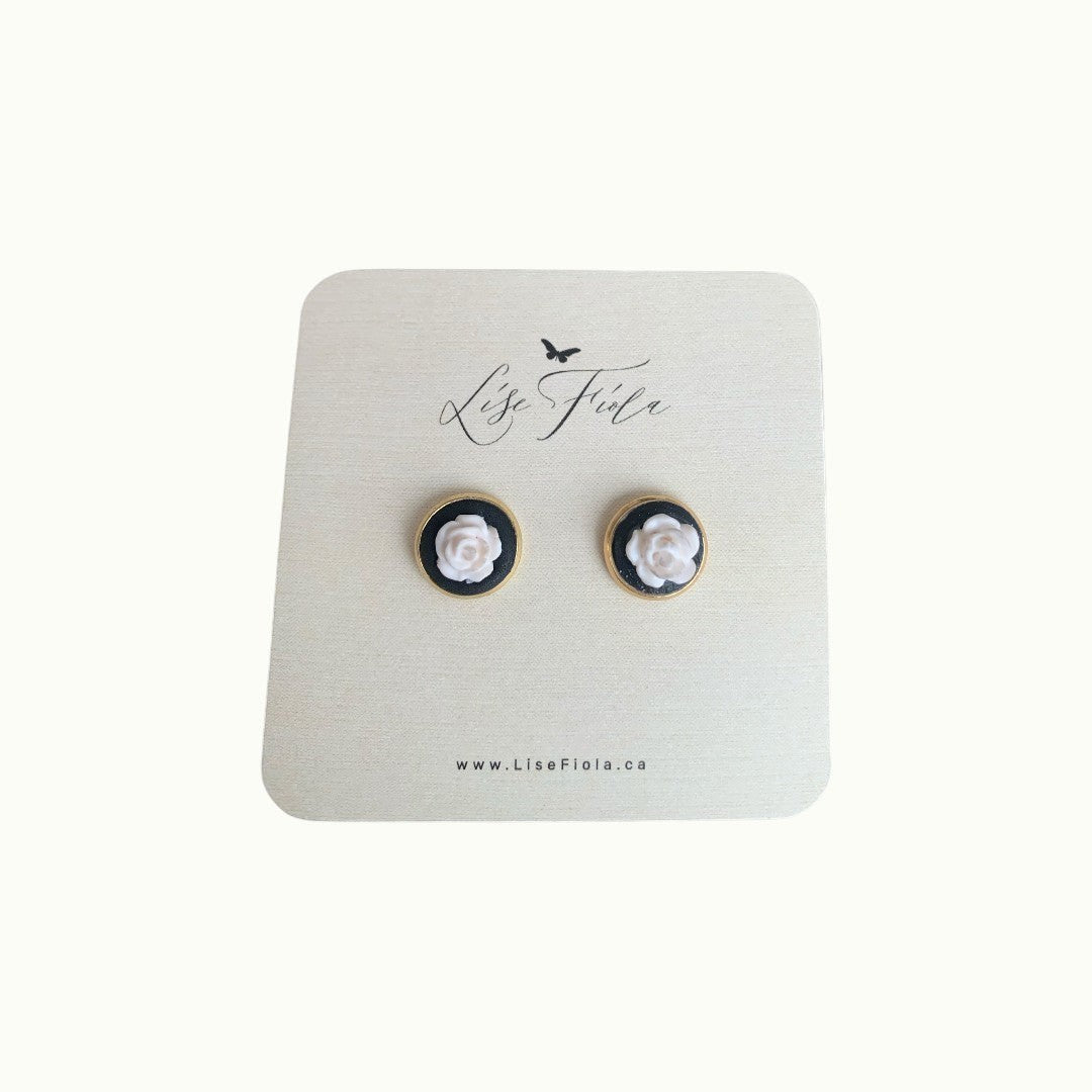 Lise Fiola Creations white rose stud earrings featuring polymer clay flowers on black with gold-plated bezels.