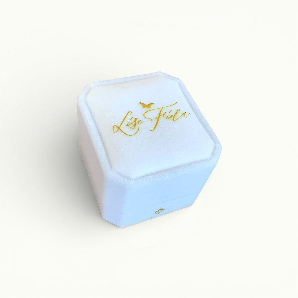 Lise Fiola Creations white velvet ring box with gold logo branding for a handcrafted marbled ring