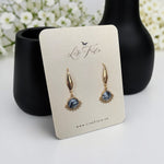 Lise Fiola Creations Wink earrings featuring marbled grey, black, and white clay with 14k gold-plated stainless steel.